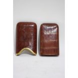 An early 20th century crocodile skin pocket cigar case with 18ct. gold mount, retailed by Philip