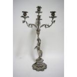 A Victorian table candelabrum having three foliate scroll arms & matching central upright sconce