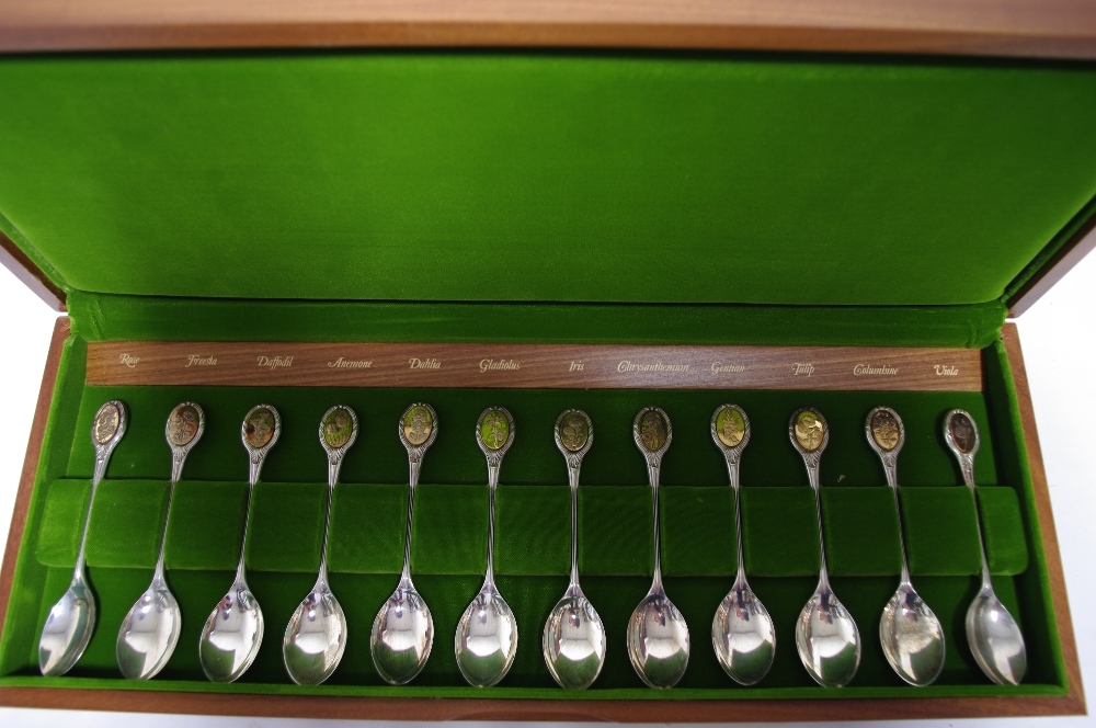 A set of twelve Royal Horticultural Society spoons, each with silver-gilt oval terminal depicting