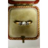 A gold ring set pearl flanked by a small diamond either side; & a pearl-set ring (one pearl