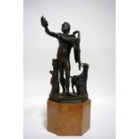 A 19th century bronze standing nude Bacchanalian figure holding a bunch of grapes aloft in his right