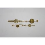 A 15ct gold bar brooch set small ruby; & three yellow metal bar brooches set seed pearls.