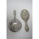 An Edwardian hand mirror with embossed scroll decoration, Birmingham 1906; & another, Birmingham