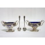A pair of Edwardian oblong two-handled salt cellar with pierced sides & blue glass liners, each on