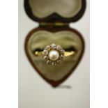A gold ring set pearl within a border of ten small diamonds; & another set citrine.