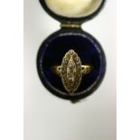 An antique diamond ring, the navette shaped panel set twenty three rose-cut stones, with clusters of