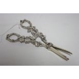 A pair of early Victorian grape scissors with cast grape-vine ring handles & pierced stems; London