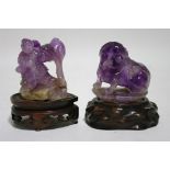 A Chinese carved amethyst quartz group of a man standing beside a large lotus bud, on rocky base,