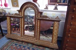 A continental carved teak & bone-inlaid overmantel mirror with arched centre panel & stylised