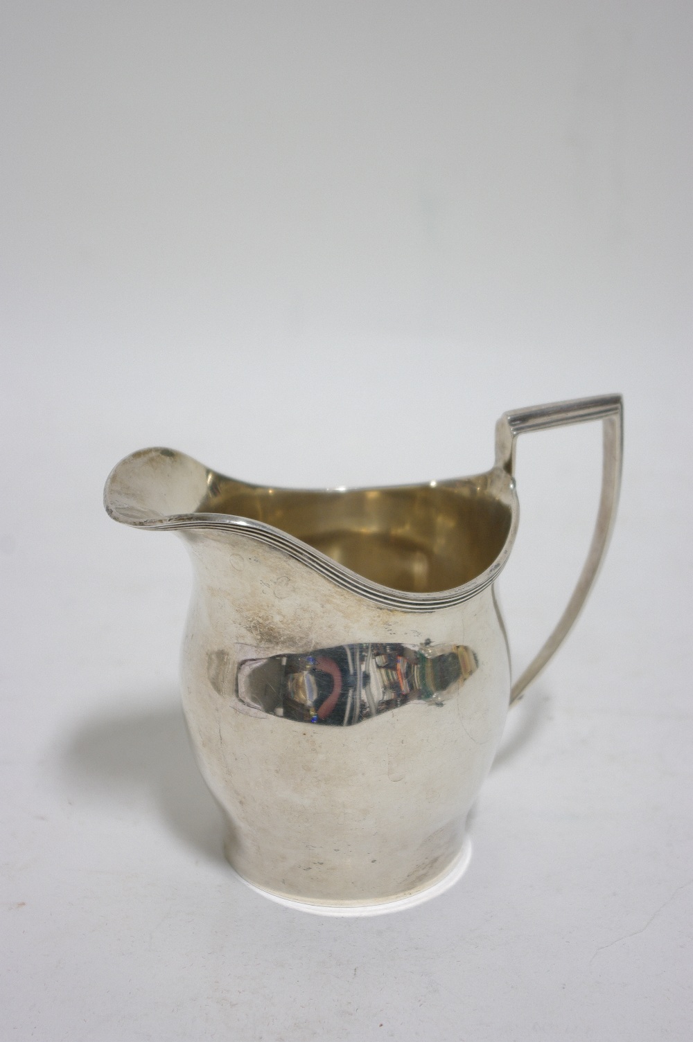 An ovoid cream jug in the early 19th century style, 4" high; Birmingham 1931, by S. Blackensee &