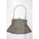 A Sterling silver mesh evening bag with pierced & floral engraved frame, & chain handle;