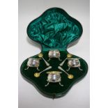 A set of four Edwardian salt cellars of rounded form with shaped gadrooned rims & gilt interiors,