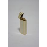 A CARTIER GOLD-PLATED & CREAM ENAMEL POCKET CIGARETTE LIGHTER of rectangular shape with one canted