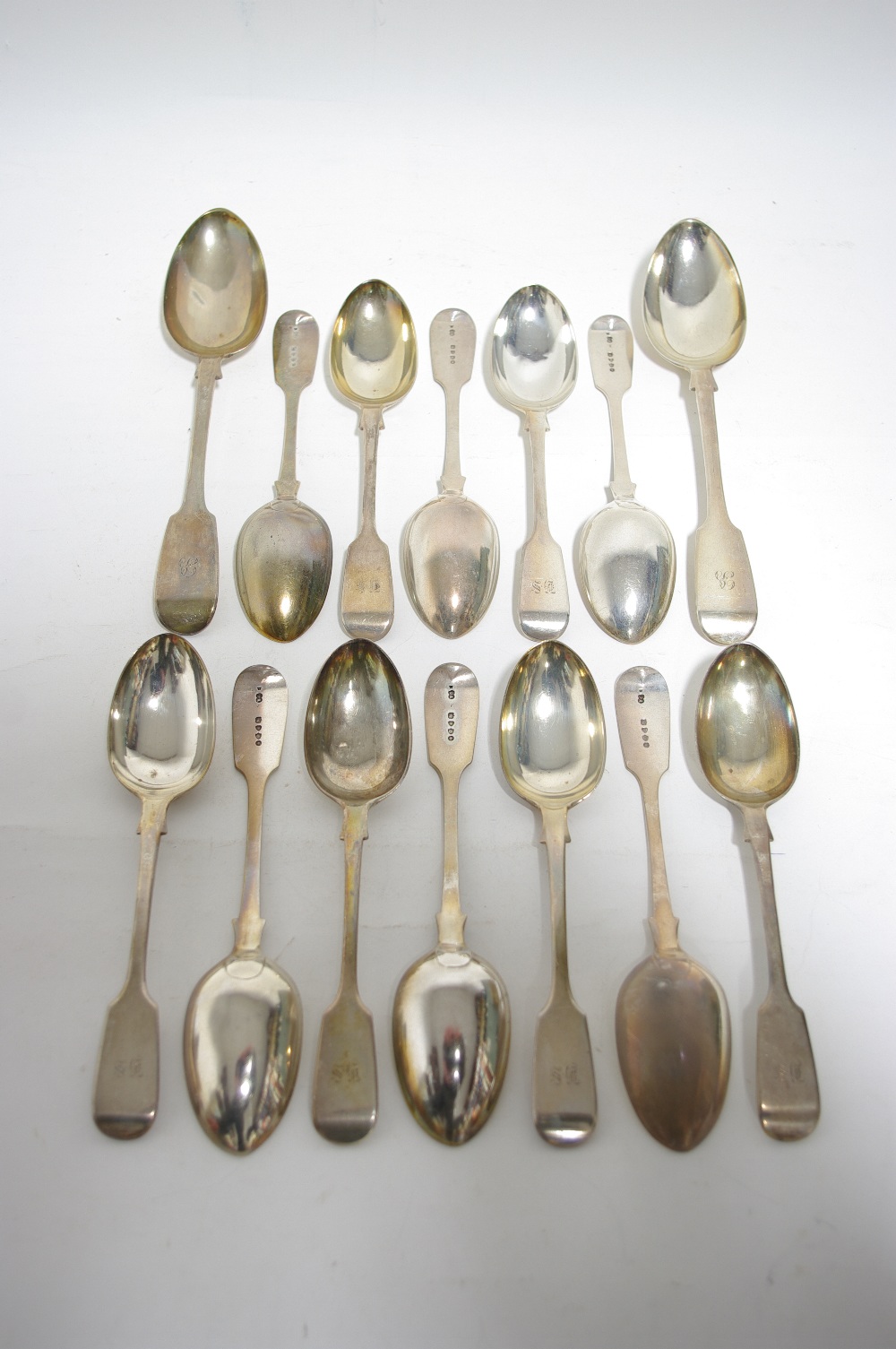 Twelve Victorian Fiddle pattern dessert spoons; London 1878, by George W. Adams (19oz.); & a pair of