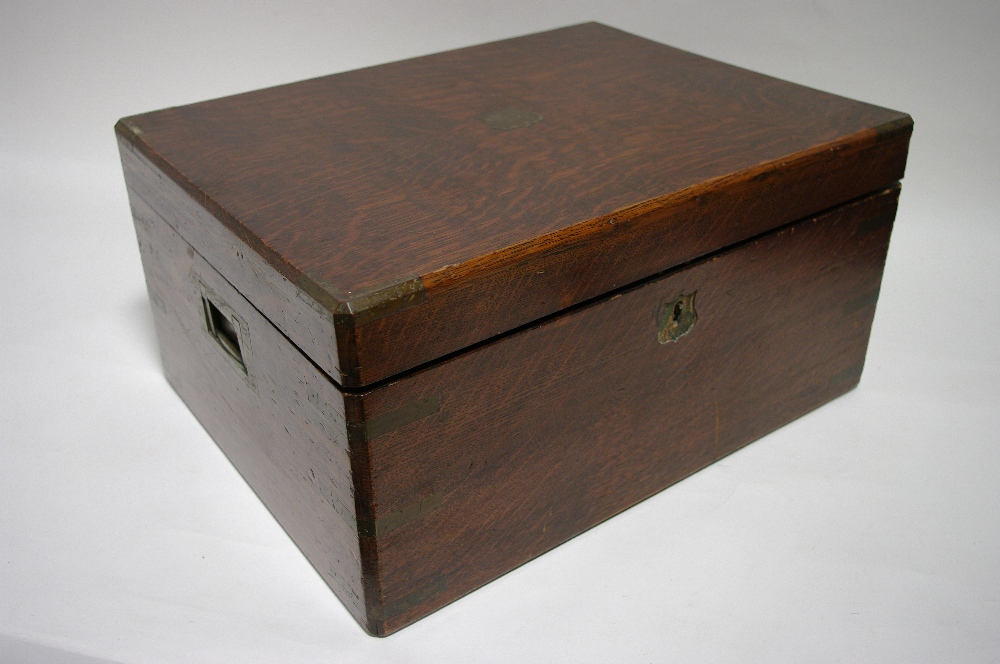 An Army & Navy oak canteen with lift lid & fitted two removable trays, part-fitted with various