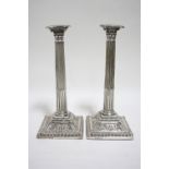 A PAIR OF EARLY GEORGE III CORINTHIAN COLUMN CANDLESTICKS, the round tapered stop-fluted stems