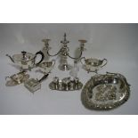 An oval three-piece tea service with narrow decorative borders, each on four scroll feet; an