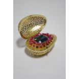 A STUART DEVLIN SILVER-GILT EGG, the pierced exterior of coral design, the interior set large