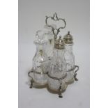 An early Victorian cruet stand in the mid-18th century style, with centre ring handle & on four
