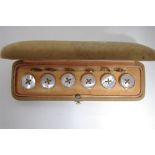 A set of six mother-of-pearl & gilt metal shirt buttons with ring fasteners, in fitted case;