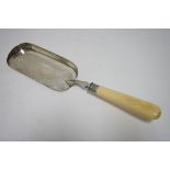 A Victorian engraved crumb scoop with ivory handle, 13" long; London 1888, by Edward Hutton.