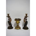 A pair of 19th century cast gilt-metal & bronzed candlesticks in the form of seated gryphon, on