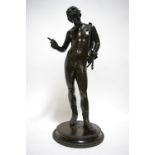 A 19th century bronze standing nude figure of Narcissus, after the antique, on circular base; 23½”