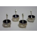 A set of four Victorian small circular salt cellars with chased flower & scroll decoration, each