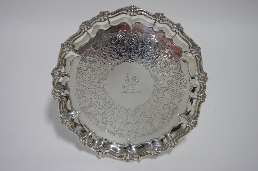 An early Victorian waiter with raised pie-crust border, engraved scrolls & family crest of a