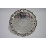 An early Victorian waiter with raised pie-crust border, engraved scrolls & family crest of a