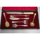 A late 19th/early 20th century serving set comprising a cake knife; three various serving forks; a