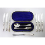 A feather-edge Christening spoon & fork, Sheffield 1911 by Cooper Bros., in fitted case; & seven tea