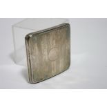 A George V engine-turned pocket cigarette case with curved profile; Birmingham 1923. (4oz.)