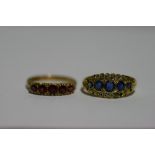 A gold ring set five graduated sapphires within a border of small diamonds (one diamond