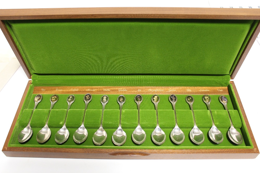 A set of twelve Royal Horticultural Society “Flower” spoons, each with gilt terminal depicting a