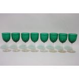 Eight emerald wine glasses on clear stems; 5” high.