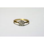 An 18ct. gold & platinum ring set cluster of small diamonds; & a similar ring set row of five