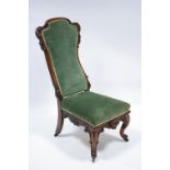 A Victorian carved walnut frame occasional chair with tall padded back & wide padded seat, on carved