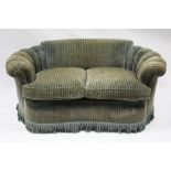 An early 20th century upholstered kidney-shaped two seater settee with low curved back & fan-