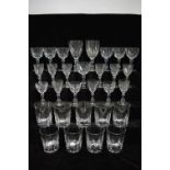 A part suite of heavy cut drinking glasses with hollow baluster stems, comprising two large goblets,
