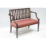 An Edwardian inlaid mahogany frame two-seater settee, the back with tapered narrow splats, each