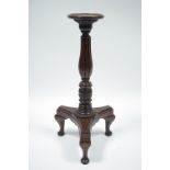 A mahogany jardinière stand with turned, reeded & carved column, on triform base; 36” high.