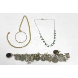 A silver curb link bracelet with numerous pendant charms, coins, etc.; a fringe necklace set