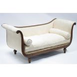 An early 19th century walnut & parcel-gilt scroll end settee with loose cushions & bolsters,