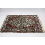 A Persian rug with three lozenge motifs to the centre, all-over multi-coloured floral design