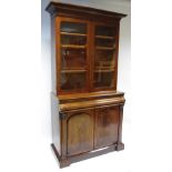 A WILLIAM IV FIGURED MAHOGANY TALL BOOKCASE, the upper part with cavetto cornice, fitted three