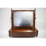 A regency mahogany rectangular swing toilet glass with turned uprights, the base fitted three