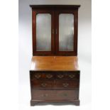 A MID-18th century “RED WALNUT” BUREAU BOOKCASE, the upper part with moulded cornice & fitted