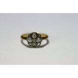 An 18ct. gold & platinum ring set cluster of five small diamonds.