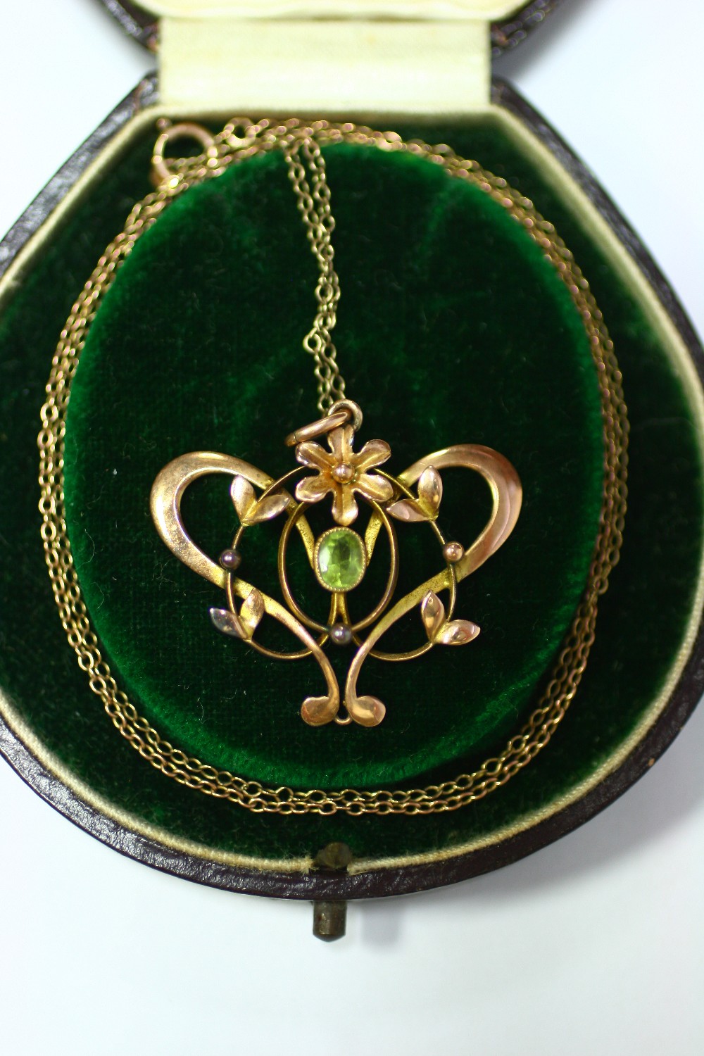 An Edwardian 9ct gold Art Nouveau style floral open-work pendant set centre peridot, on fine-link - Image 2 of 3